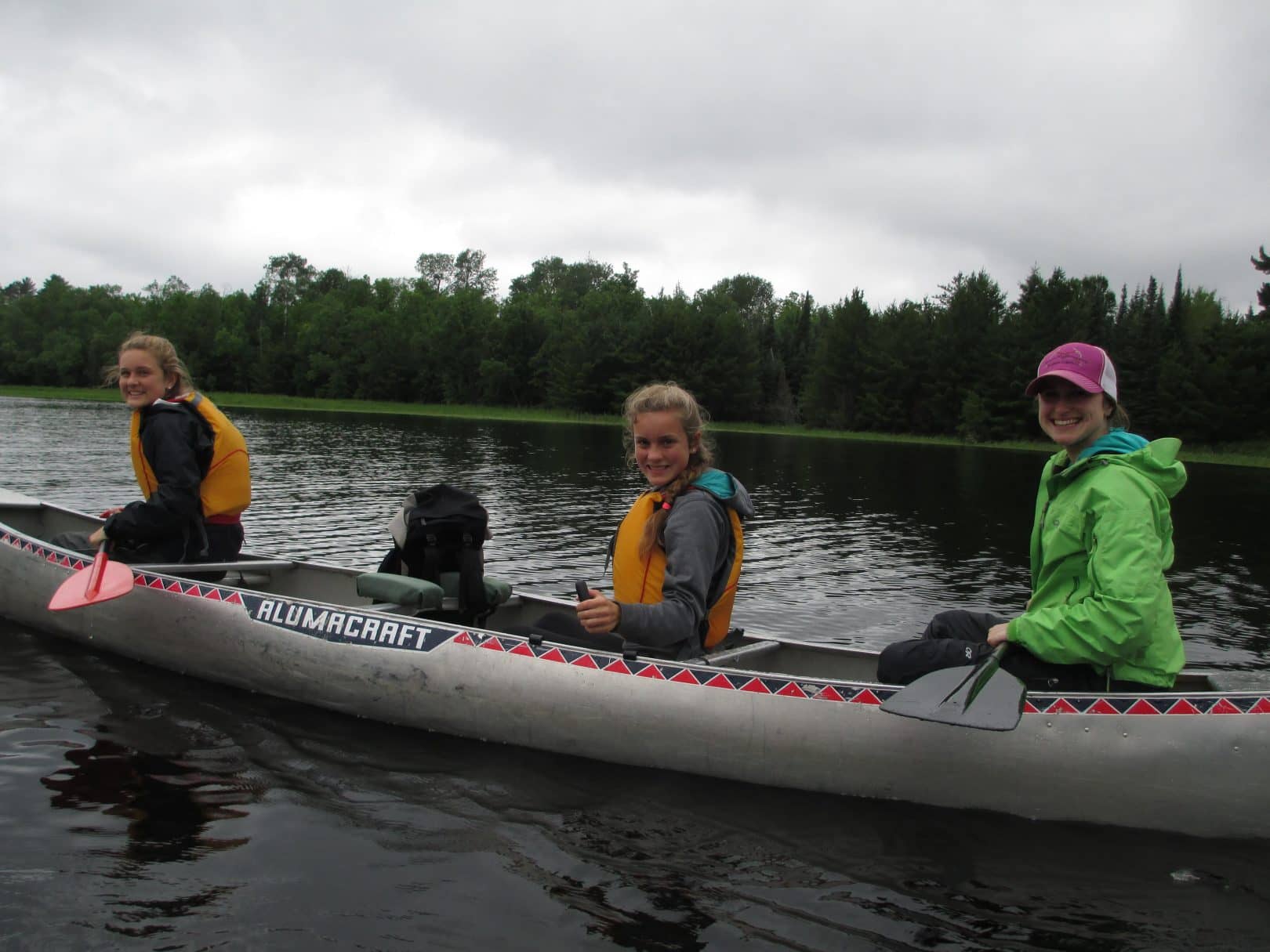 3 young recruits canoeing on a wide open lake